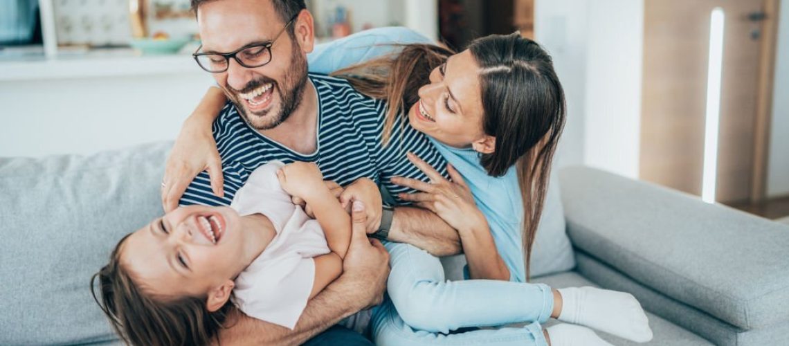 Family with daughter having fun at home