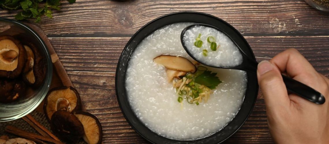 Testy rice porridge with soft boiled egg, shiitake mushroom, slice ginger and slice scallion for breakfast in the morning or light meal.
