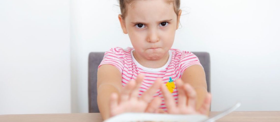 Little girl refusing to eat her food